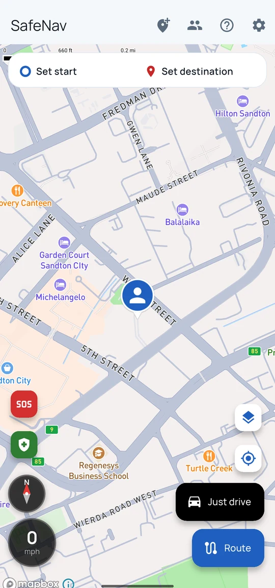The SafeNav home map showing your position as a round marker, with the SOS button, the Get to safety button, the compass and speedometer on the left, and the Just drive and Route buttons at the bottom right.